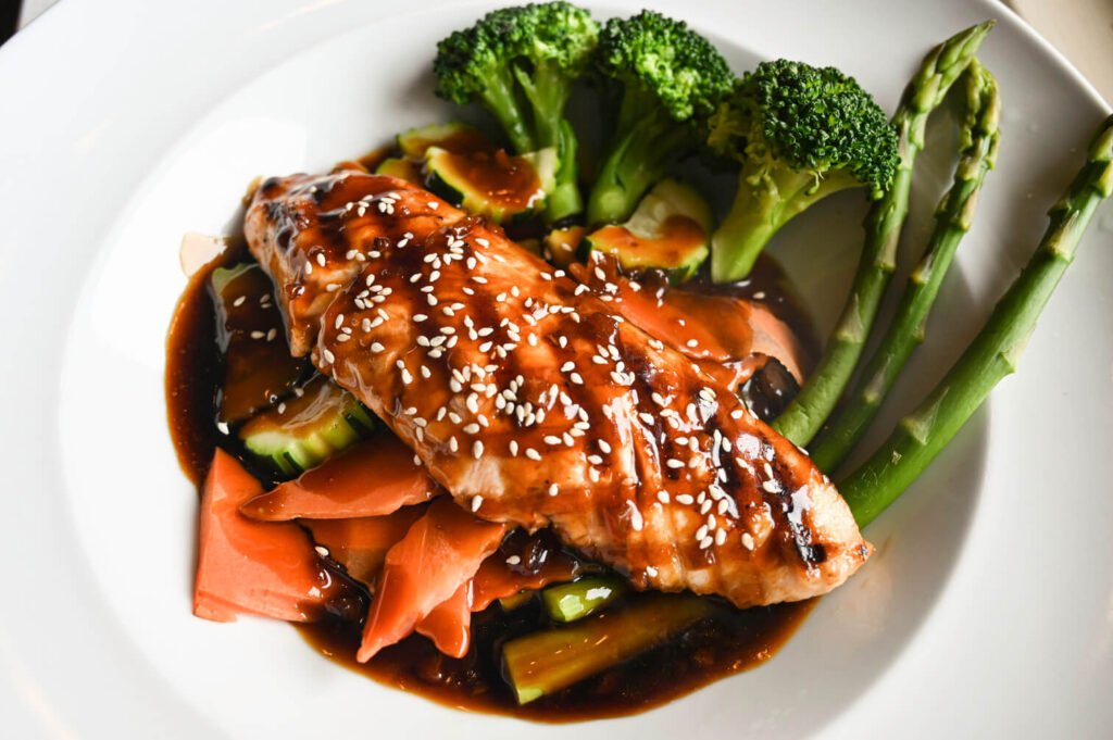 Juicy grilled chicken steak drizzled with savory teriyaki sauce, served with fresh vegetables.